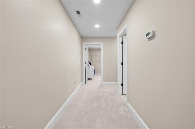 hallway featuring recessed lighting, visible vents, baseboards, and light carpet