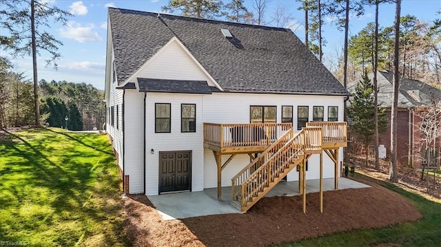 back of property featuring a patio, stairway, roof with shingles, a yard, and a deck