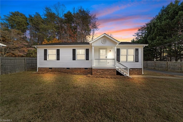 ranch-style home featuring a yard