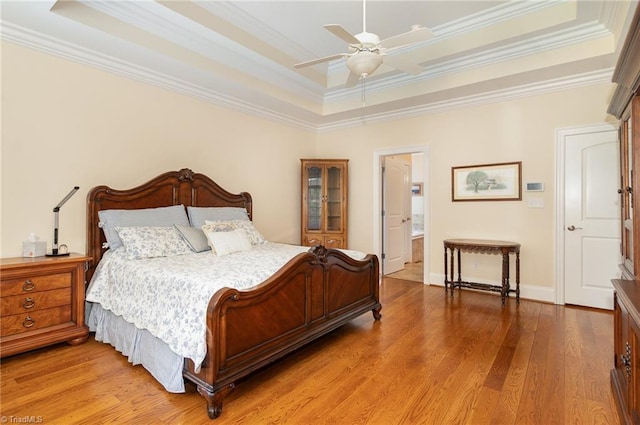 7469 Henson Forest Dr, Summerfield, NC 27358 - bedroom featuring a raised ceiling, ornamental molding, light wood-type flooring, baseboards, and ceiling fan