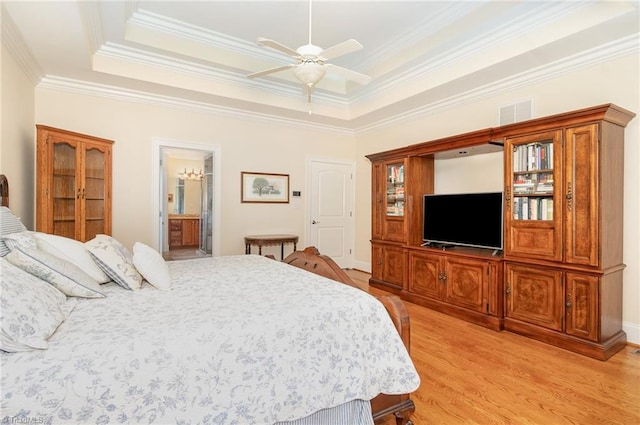 7469 Henson Forest Dr, Summerfield, NC 27358 - bedroom featuring light wood-type flooring, crown molding, a tray ceiling, ceiling fan, and ensuite bathroom