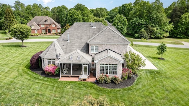 7469 Henson Forest Dr, Summerfield, NC 27358 - rear view of property with a sunroom and a lawn