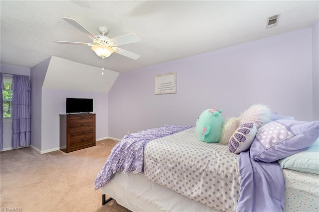bedroom featuring a ceiling fan, visible vents, baseboards, lofted ceiling, and light carpet