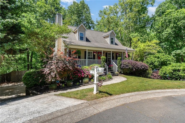 cape cod house with a porch, a front lawn, fence, and a chimney