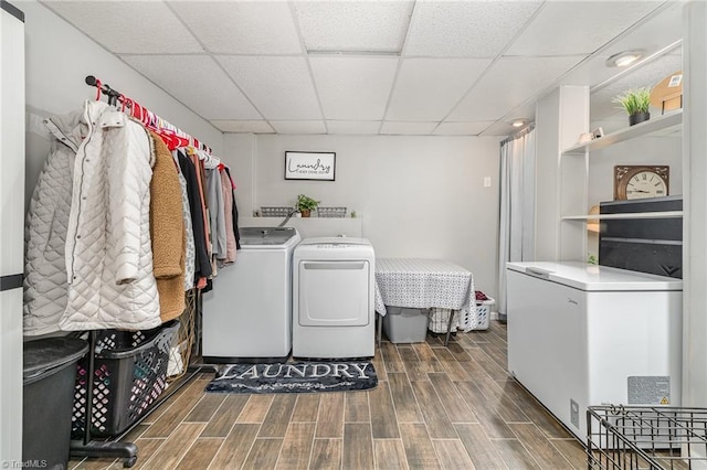laundry room with laundry area, wood finish floors, and washer and clothes dryer