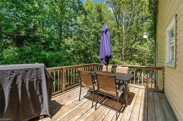 wooden terrace featuring outdoor dining space