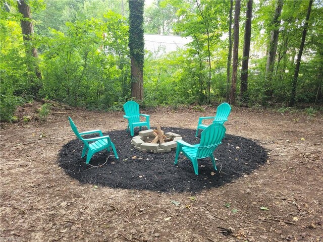 view of community featuring an outdoor fire pit