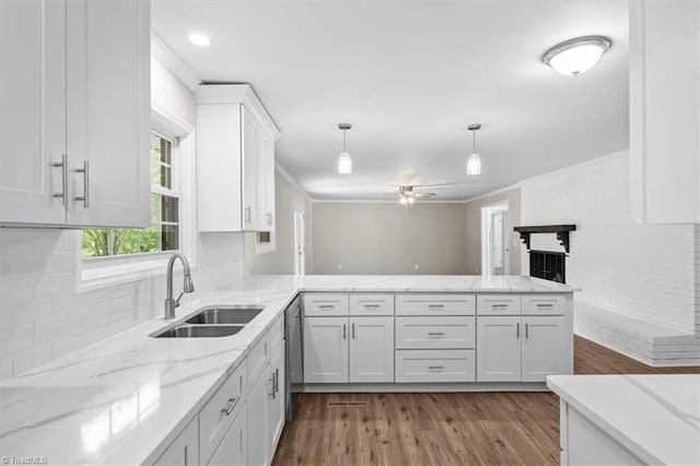 2517 Hopewell Friends Rd, Asheboro, NC 27205 - kitchen with white cabinetry, dark wood-style floors, a peninsula, crown molding, and decorative light fixtures