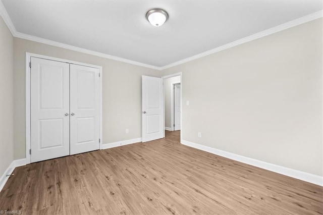2517 Hopewell Friends Rd, Asheboro, NC 27205 - unfurnished bedroom featuring wood finished floors, crown molding, and a closet