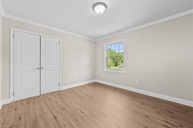 2517 Hopewell Friends Rd, Asheboro, NC 27205 - unfurnished bedroom with light wood-style floors, ornamental molding, and a closet
