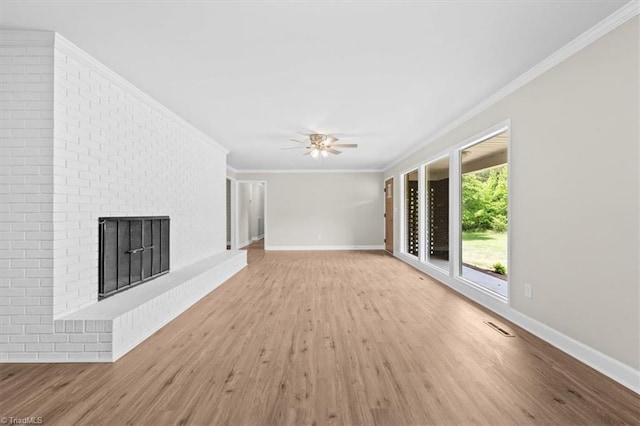 2517 Hopewell Friends Rd, Asheboro, NC 27205 - unfurnished living room with wood finished floors, crown molding, ceiling fan, and a brick fireplace