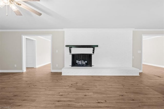 2517 Hopewell Friends Rd, Asheboro, NC 27205 - unfurnished living room with wood finished floors, a brick fireplace, ceiling fan, ornamental molding, and lofted ceiling