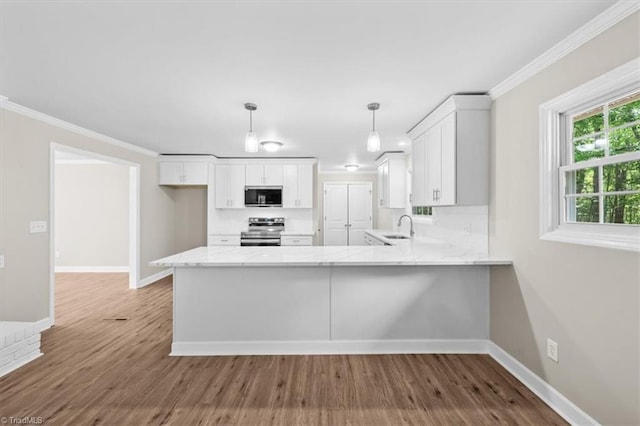 2517 Hopewell Friends Rd, Asheboro, NC 27205 - kitchen featuring appliances with stainless steel finishes, ornamental molding, white cabinetry, light stone counters, and a peninsula