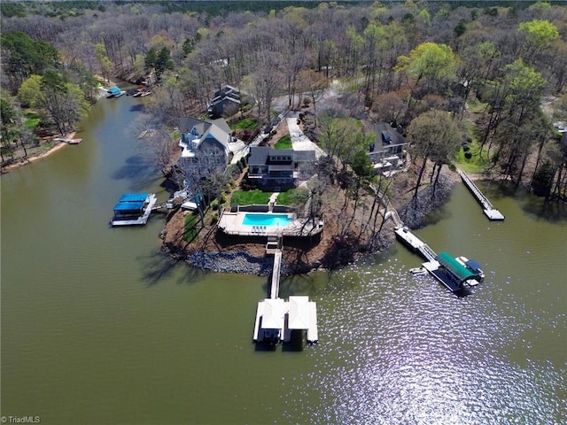 bird's eye view featuring a wooded view and a water view