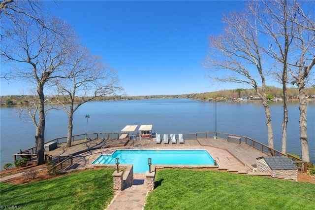 view of swimming pool featuring a fenced in pool, a water view, and a yard
