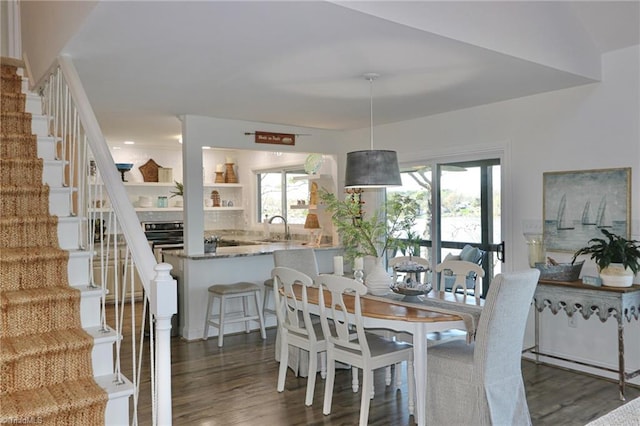 dining room featuring stairs and wood finished floors