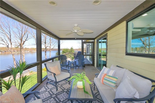 sunroom / solarium featuring outdoor lounge area, a water view, and a ceiling fan