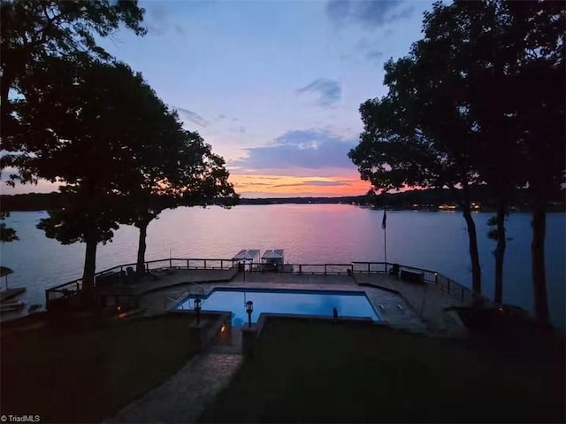 view of pool with a fenced in pool and a water view