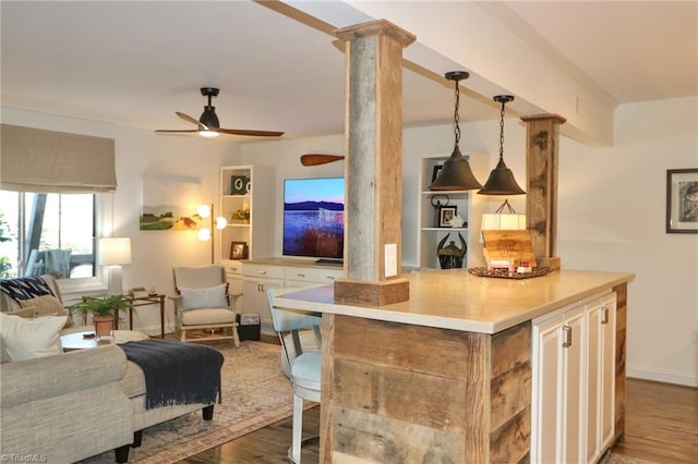 kitchen featuring light countertops, wood finished floors, open floor plan, decorative light fixtures, and ceiling fan