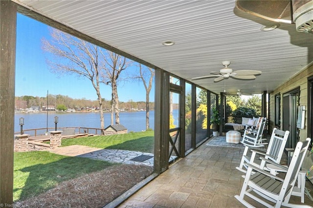 view of patio with a ceiling fan and a water view