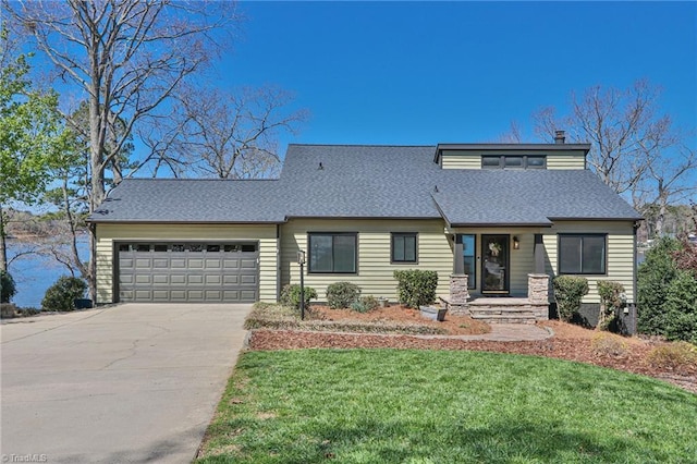view of front of home with a shingled roof, concrete driveway, a front lawn, and an attached garage