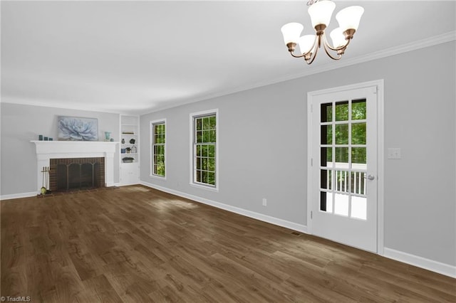 2665 Kecoughtan Rd, Pfafftown, NC 27040 - unfurnished living room with a chandelier, ornamental molding, built in shelves, baseboards, and dark wood finished floors