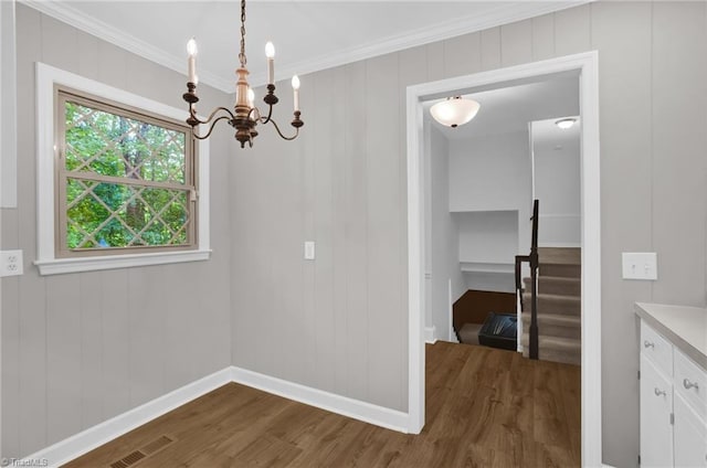 2665 Kecoughtan Rd, Pfafftown, NC 27040 - unfurnished dining area featuring dark wood-style flooring, a chandelier, ornamental molding, and baseboards