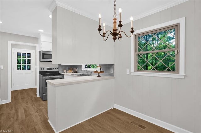2665 Kecoughtan Rd, Pfafftown, NC 27040 - kitchen featuring stainless steel appliances, light countertops, dark wood-style flooring, a chandelier, and a sink