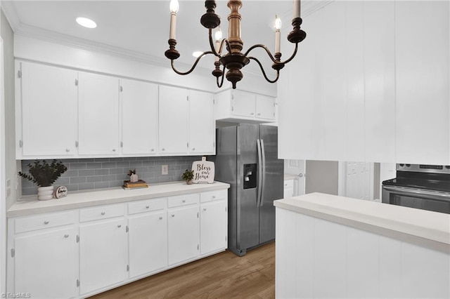 2665 Kecoughtan Rd, Pfafftown, NC 27040 - kitchen featuring appliances with stainless steel finishes, a chandelier, white cabinetry, tasteful backsplash, and light countertops