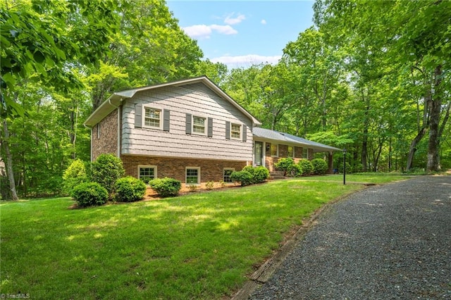 2665 Kecoughtan Rd, Pfafftown, NC 27040 - view of side of home featuring a lawn and brick siding