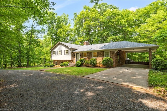 2665 Kecoughtan Rd, Pfafftown, NC 27040 - split level home featuring concrete driveway, a chimney, brick siding, a carport, and a front yard