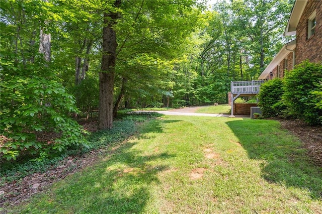2665 Kecoughtan Rd, Pfafftown, NC 27040 - view of green lawn featuring a deck and central AC unit