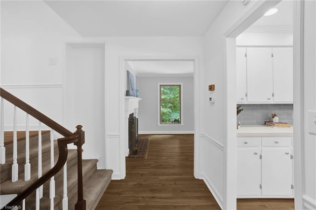 2665 Kecoughtan Rd, Pfafftown, NC 27040 - corridor featuring dark wood-type flooring, stairway, ornamental molding, and baseboards