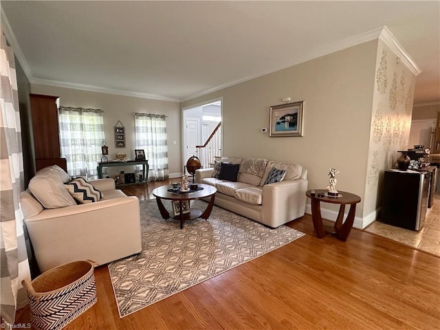 living room featuring ornamental molding and light wood-type flooring