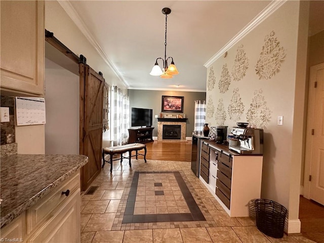 kitchen with ornamental molding, light tile patterned floors, a barn door, pendant lighting, and a notable chandelier