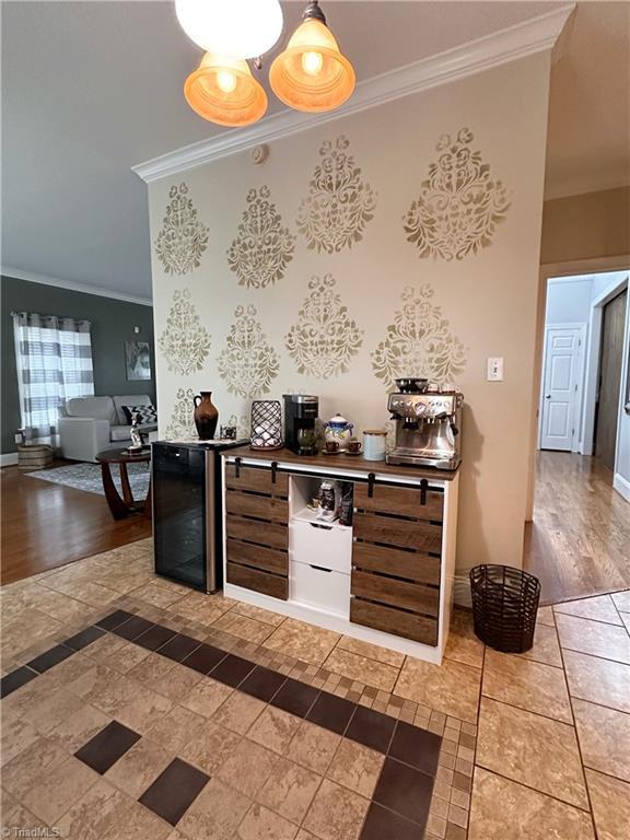 kitchen featuring ornamental molding and wine cooler