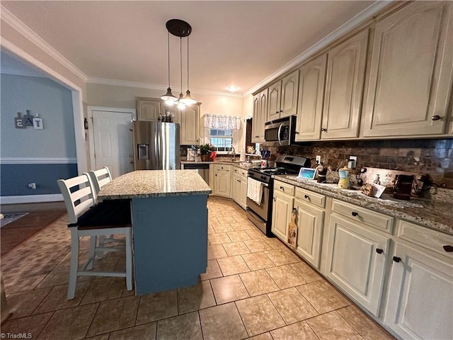 kitchen with a breakfast bar area, stainless steel appliances, light stone countertops, pendant lighting, and a kitchen island