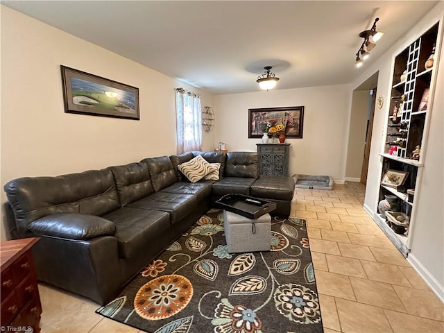 living room featuring track lighting and light tile patterned floors