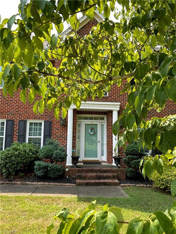 view of exterior entry featuring a yard