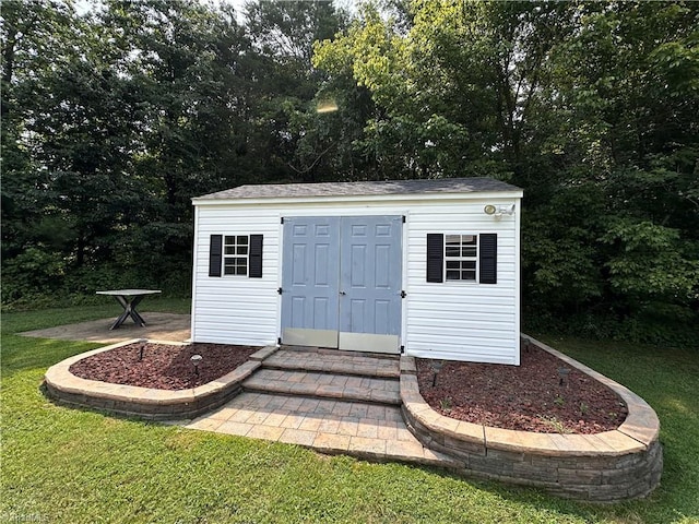 view of outbuilding with a lawn