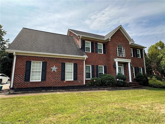 colonial inspired home with a front yard