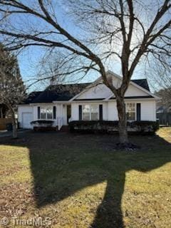 view of front of home with a garage and a front yard