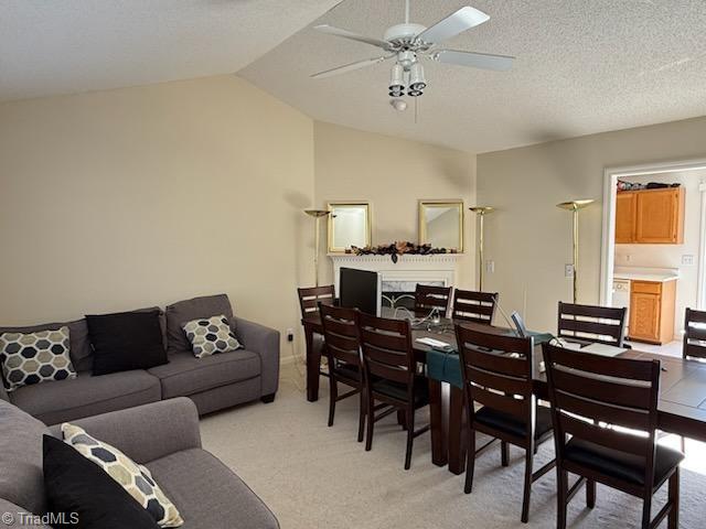 interior space with a textured ceiling, vaulted ceiling, and ceiling fan