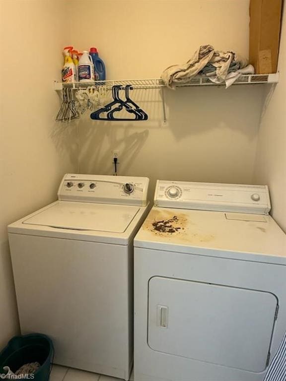 laundry room featuring tile patterned flooring and washer and clothes dryer