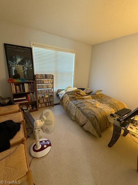 bedroom featuring a textured ceiling and carpet