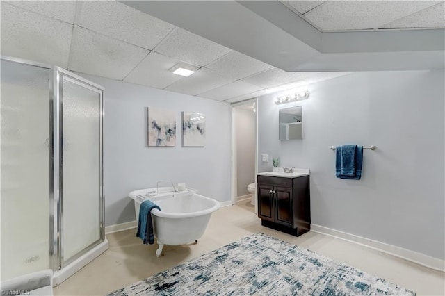 full bathroom featuring a paneled ceiling, vanity, plus walk in shower, toilet, and concrete floors