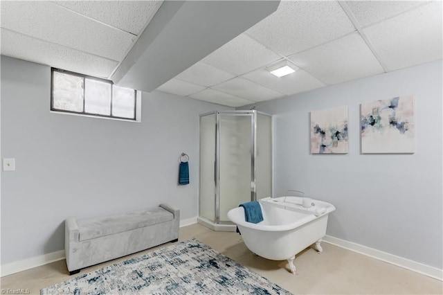 bathroom with a drop ceiling and an enclosed shower