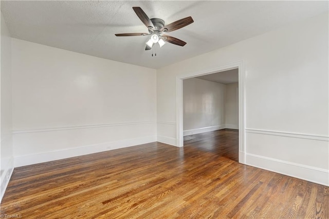 empty room with ceiling fan and dark wood-type flooring