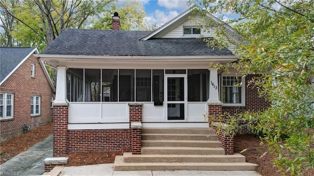 view of front facade with a sunroom