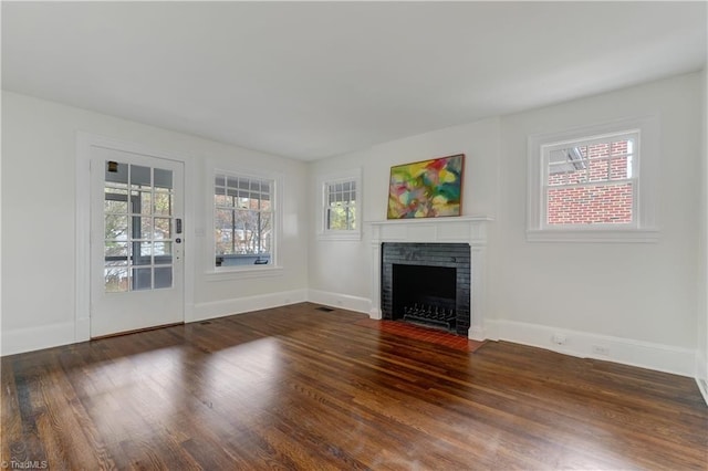 unfurnished living room featuring dark hardwood / wood-style flooring